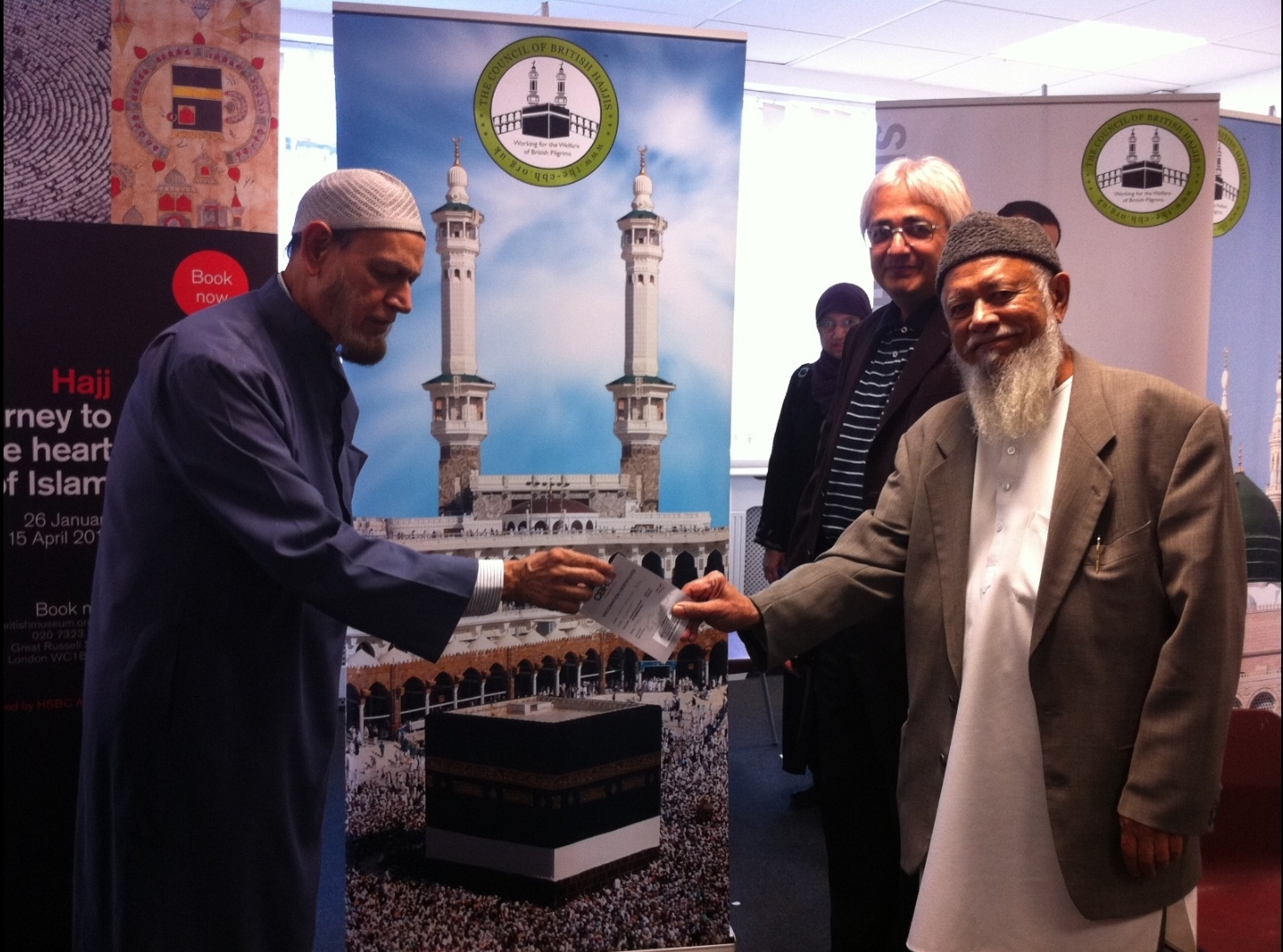 Dr Syed Mohiuddin (Left) presents Lord Adam Patel with his Meningitis ACWY Certificate of Immunisation at our 1st Hajj Vaccination Clinic at the London Muslim Centre (Sept 2012). 