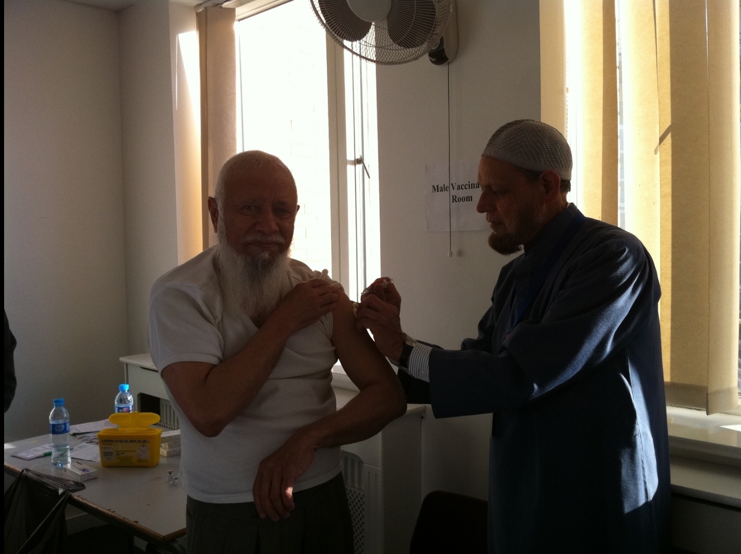 Dr Syed Mohiuddin administering the Meningitis ACWY vaccination to Lord Adam Patel at our 1st Hajj Vaccination Clinic at the London Muslim Centre (Sept 2012). 